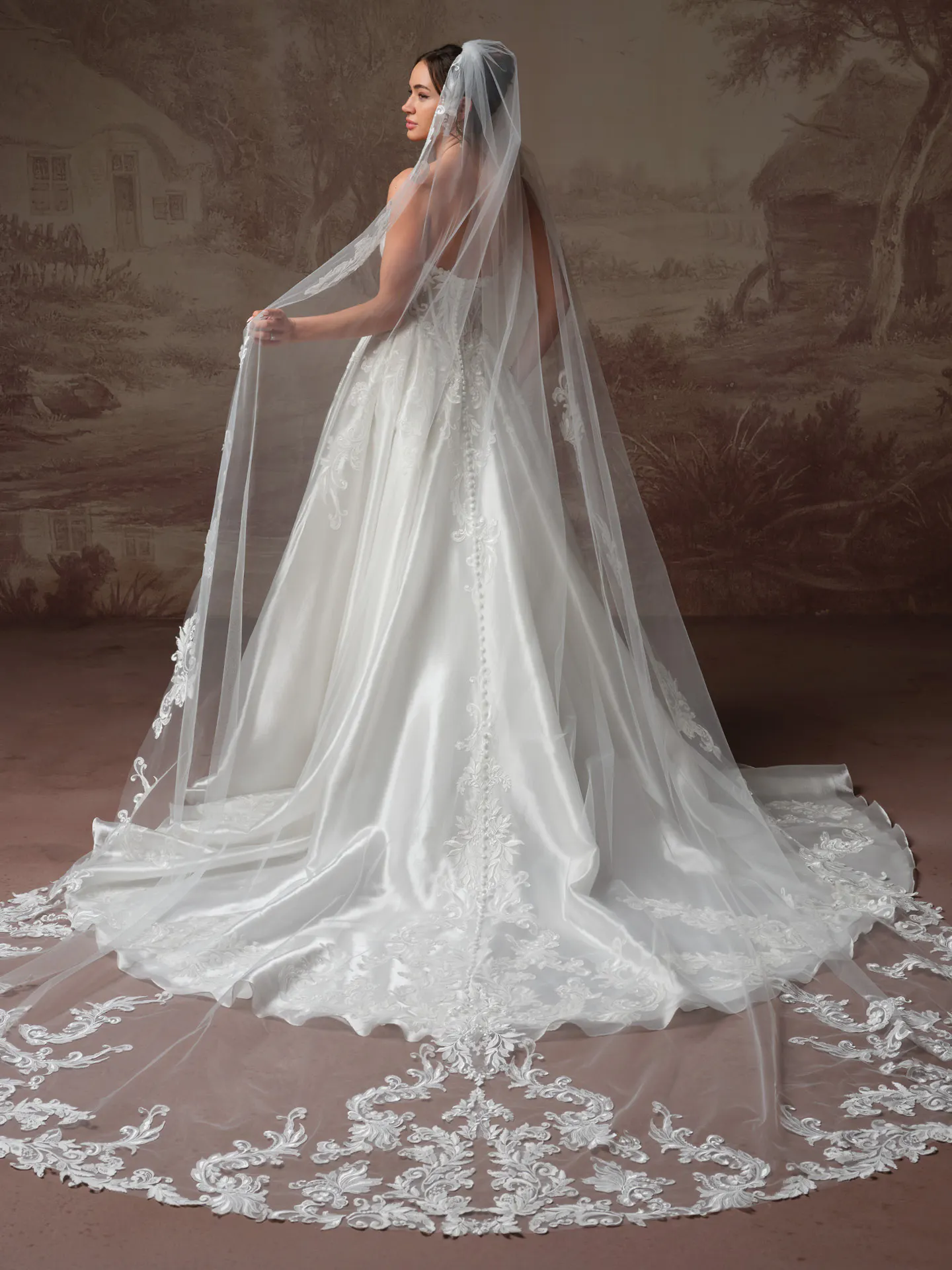 Dahlia modest wedding dress with long satin skirt and long trailing sheer train.