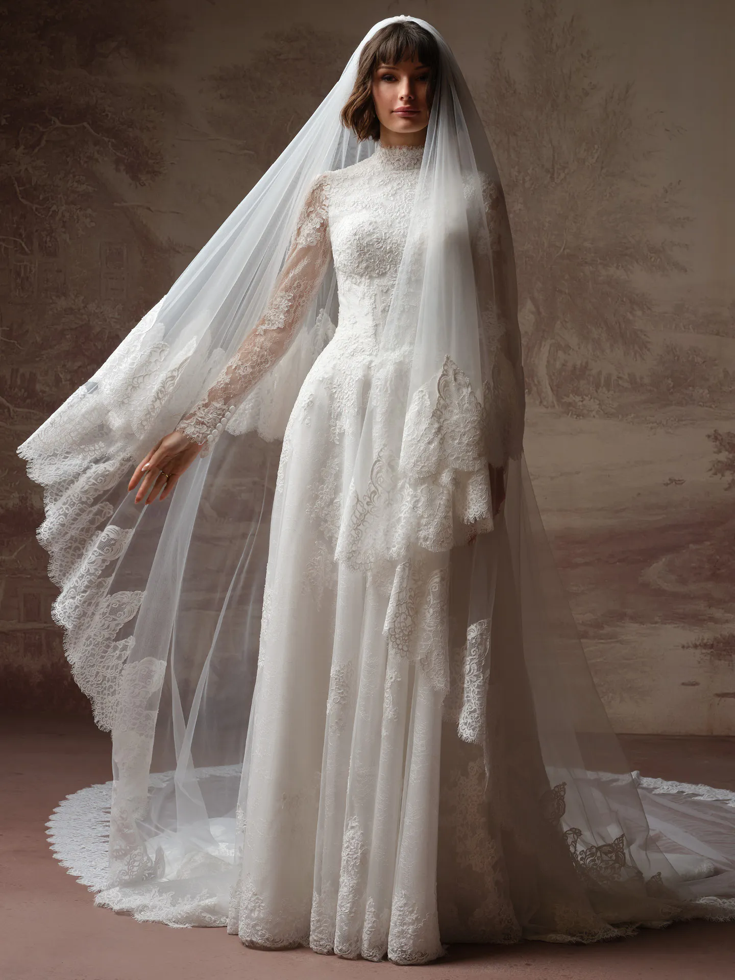Maggie Sottero Dominique front view lace wedding dress with high neck and veil.