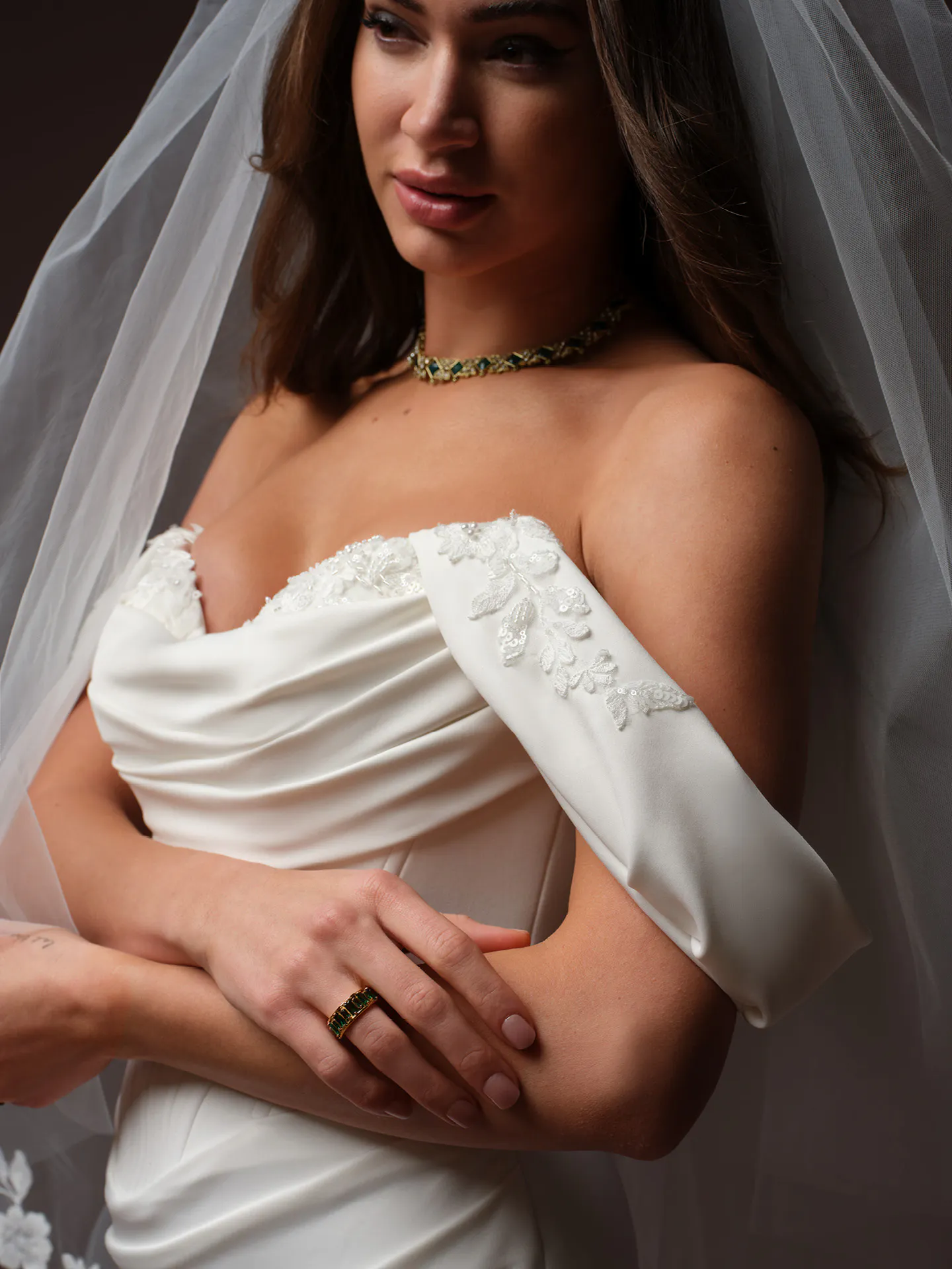 Maggie Sottero Justina wedding dress close up with beaded bodice and off-shoulder design.