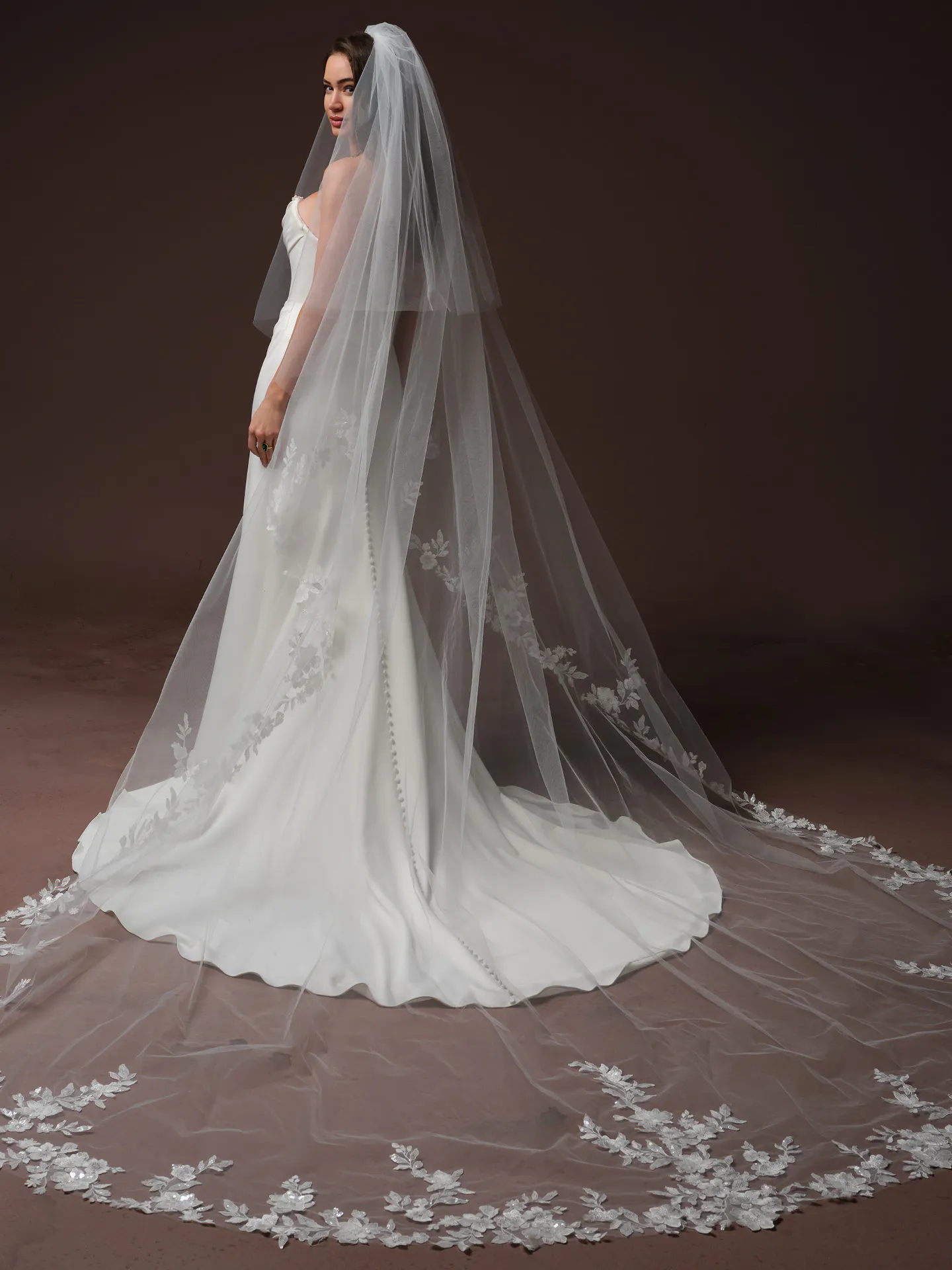 Maggie Sottero Justina side view with veil and floral lace train.