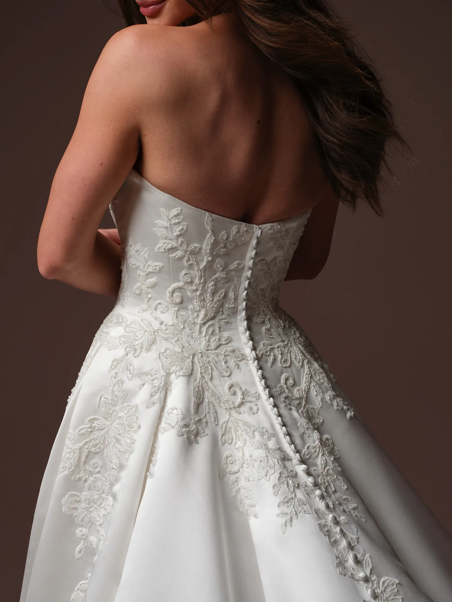 Maggie Sottero Landis back view lace satin ballgown with button details.