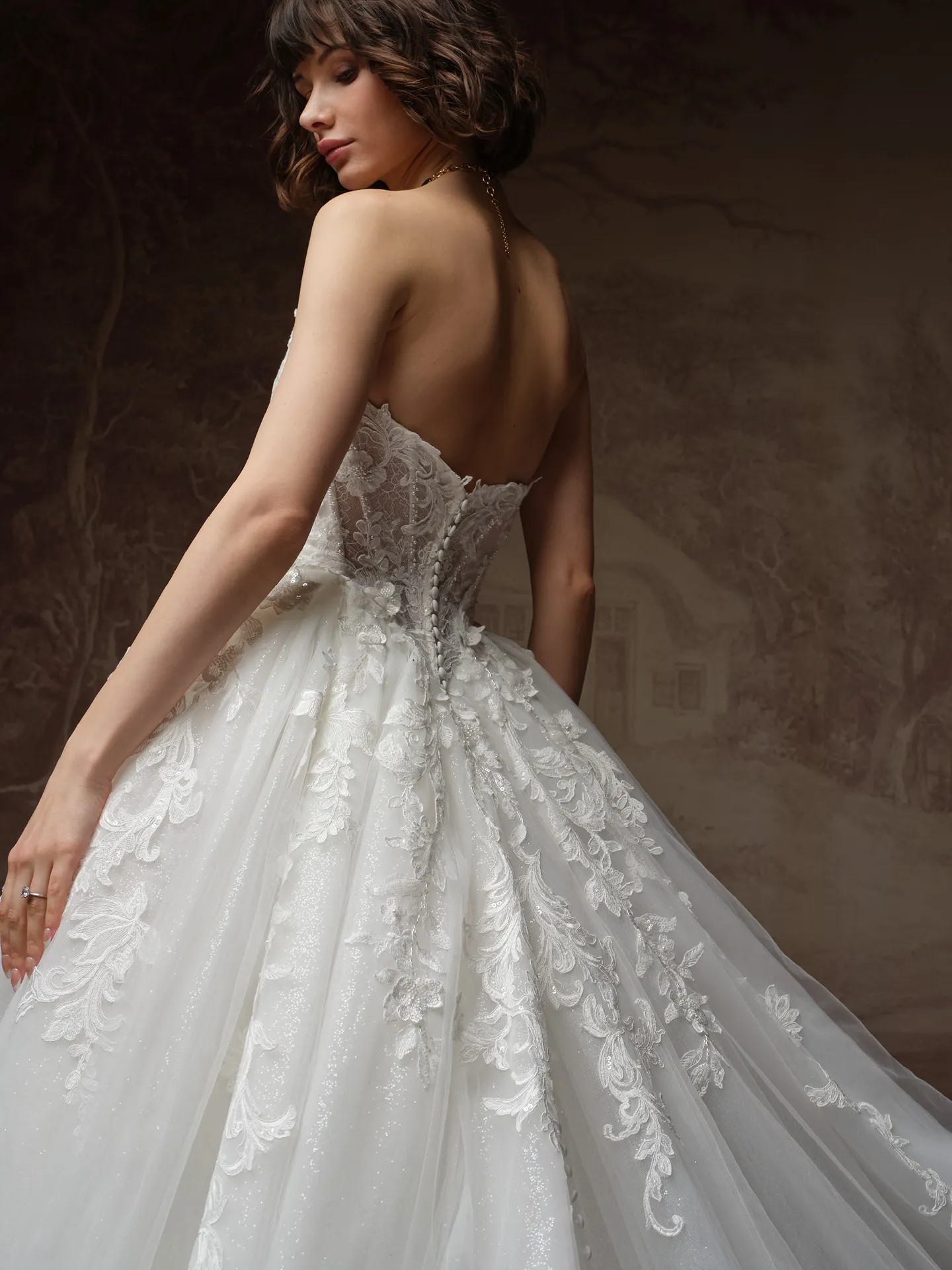Maggie Sottero Lyra back view, glitter tulle and basque waist wedding dress.