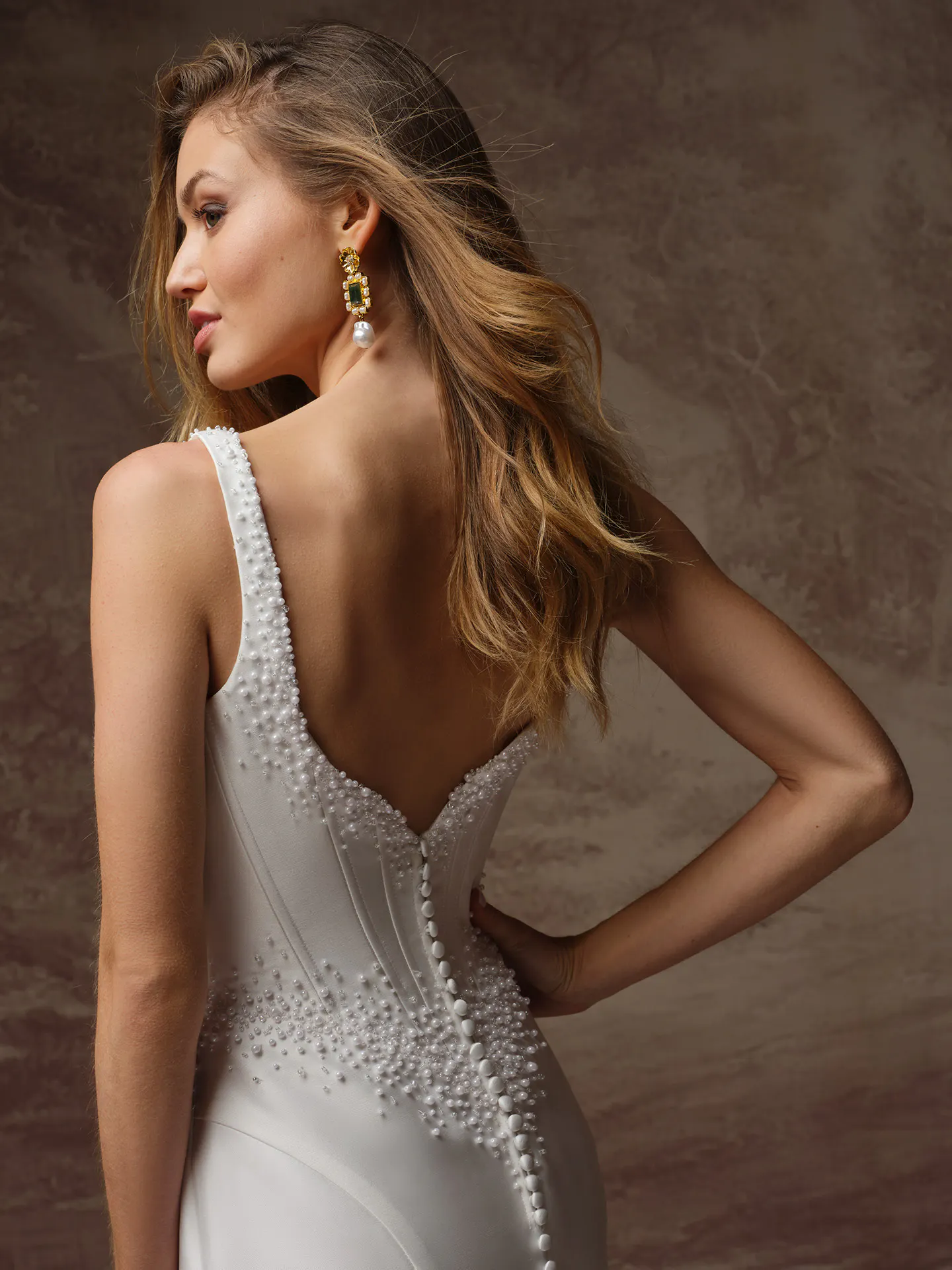 Maggie Sottero Melissa back view with pearl accents on satin mermaid bridal dress.