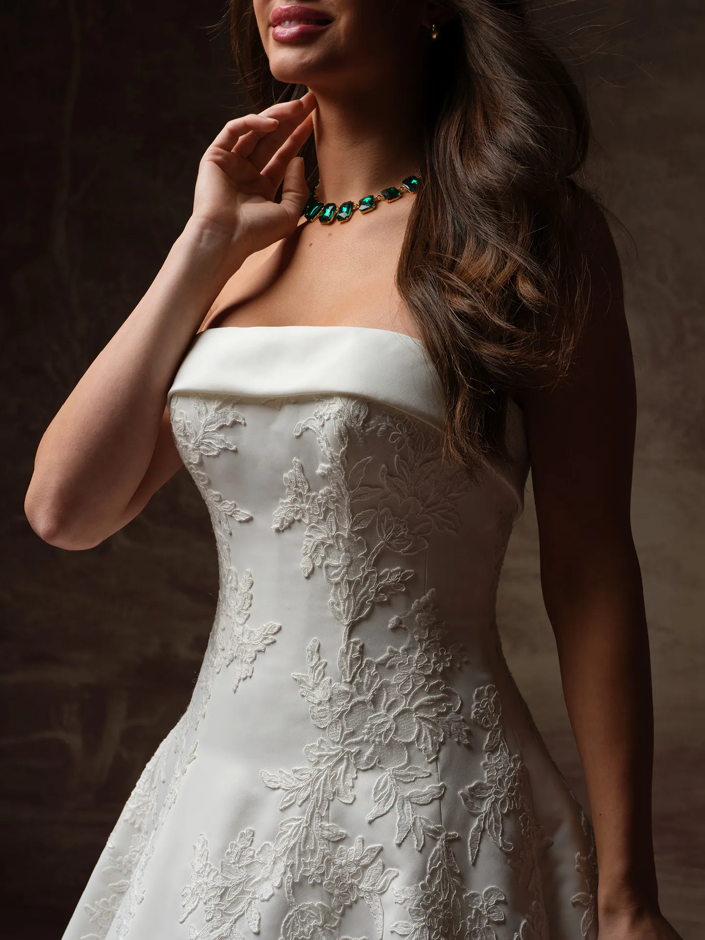 Maggie Sottero Mileva dress front view, lace detail, strapless, green necklace.