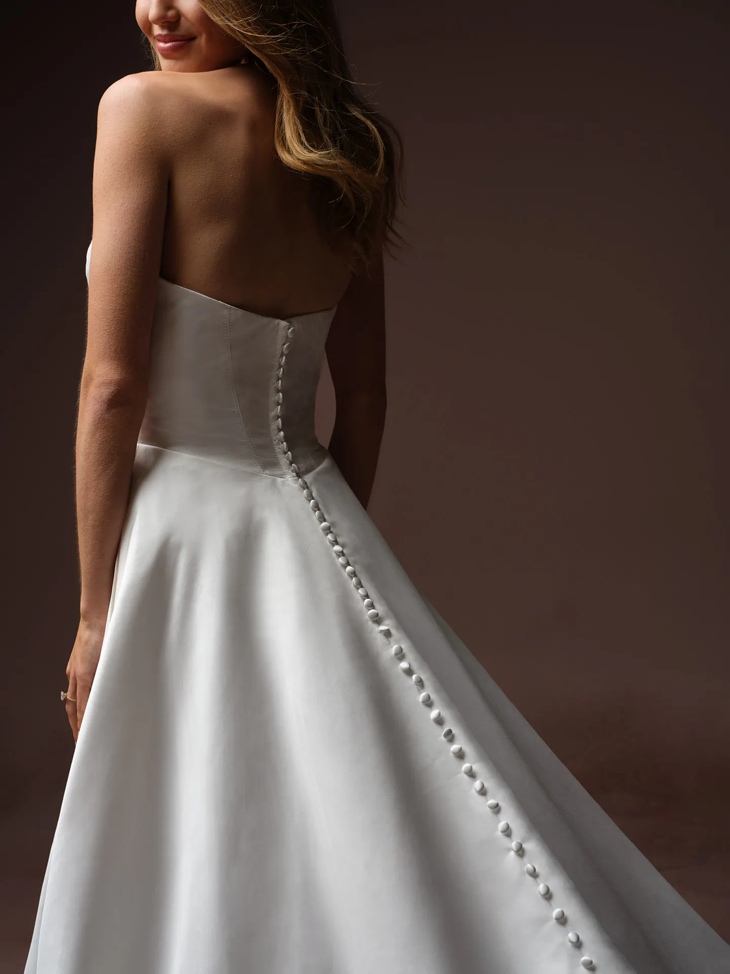 Maggie Sottero Morganna back view strapless satin A-line wedding dress.