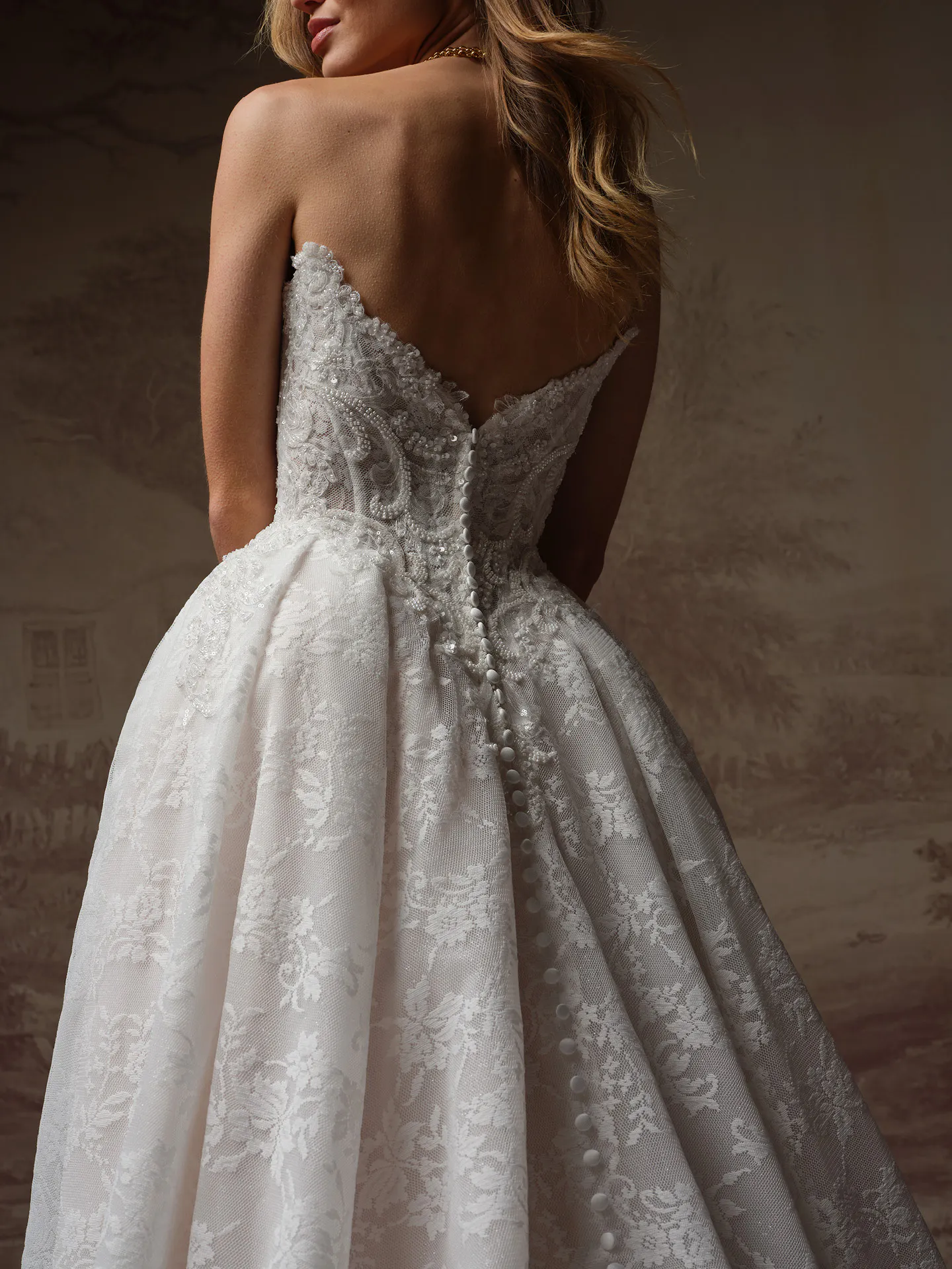 Maggie Sottero Ryland back view lace ballgown with button detail.