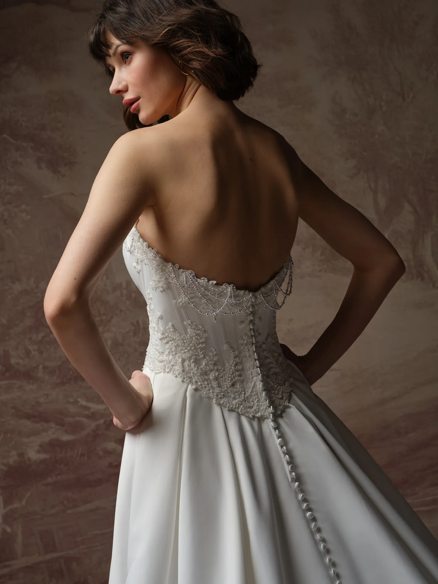 Maggie Sottero Seattle back view satin A Line with pearl detail.