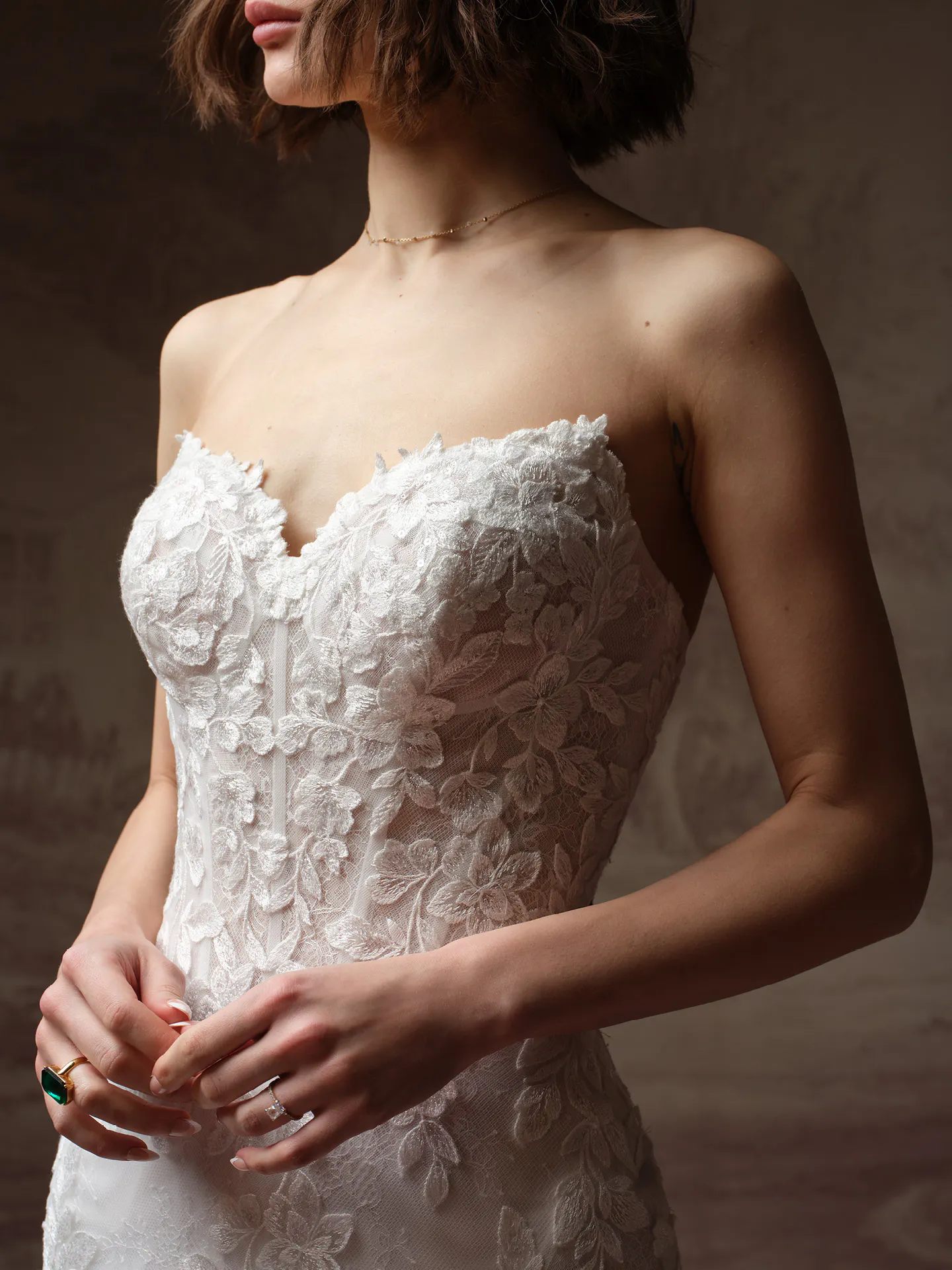 Rebecca Ingram Brandy fit-and-flare wedding dress with floral accents, front view.