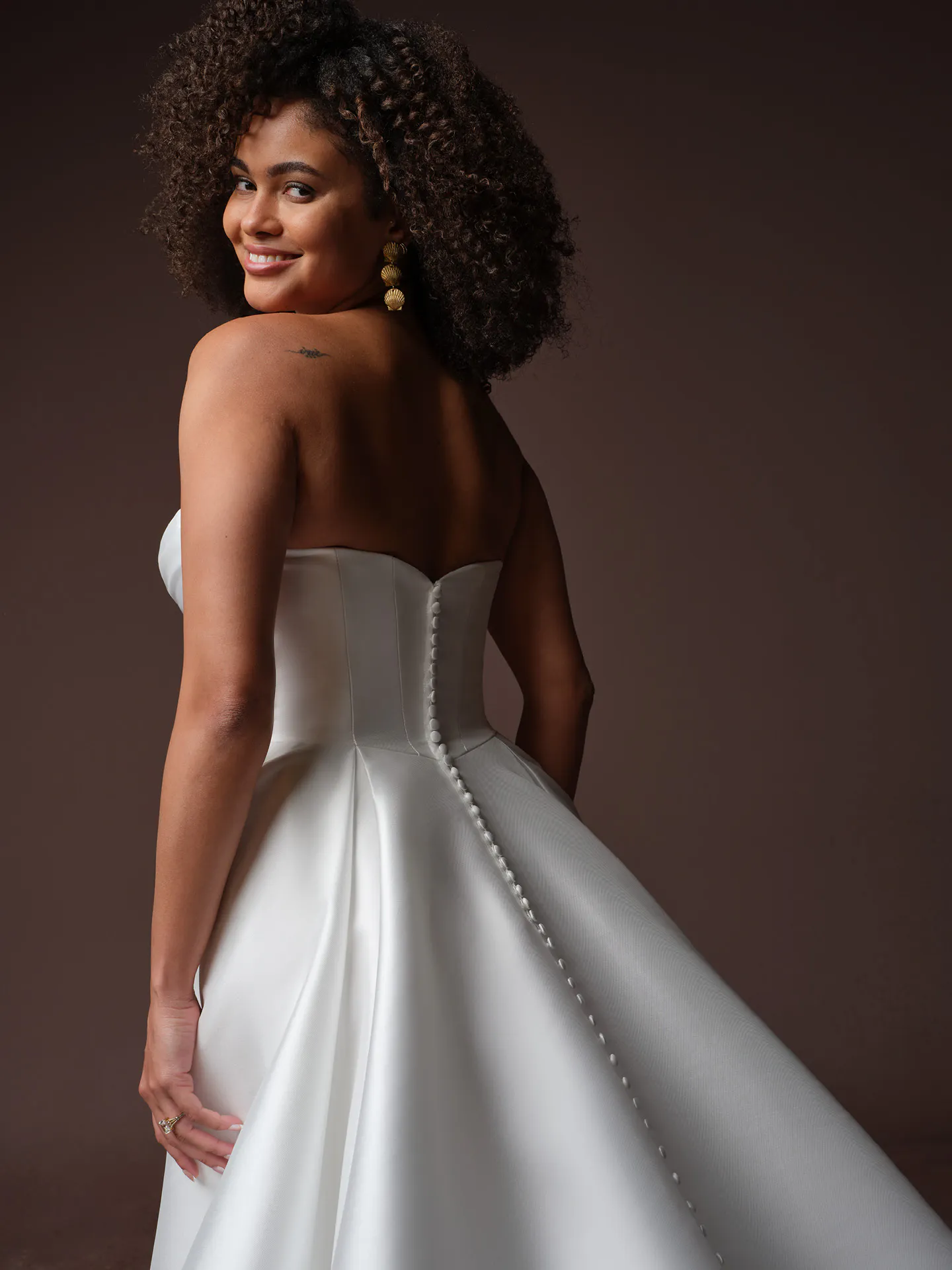 Rebecca Ingram Daphne, back view A-line wedding dress with draped bodice and button detail.