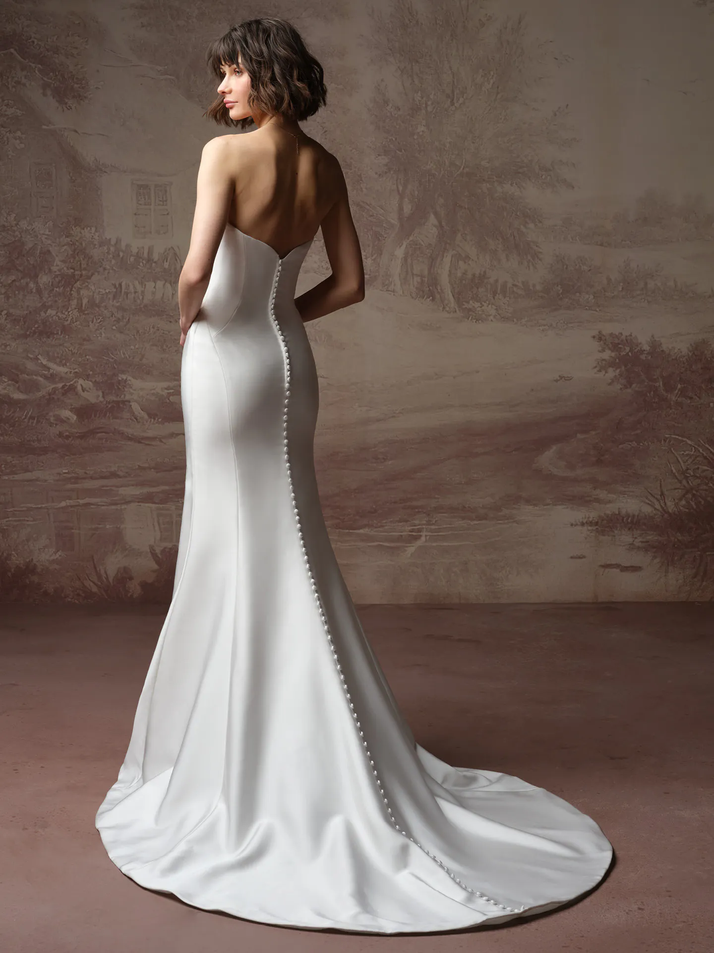 Rebecca Ingram Kayla, back view sheath with draped bodice in elegant setting.