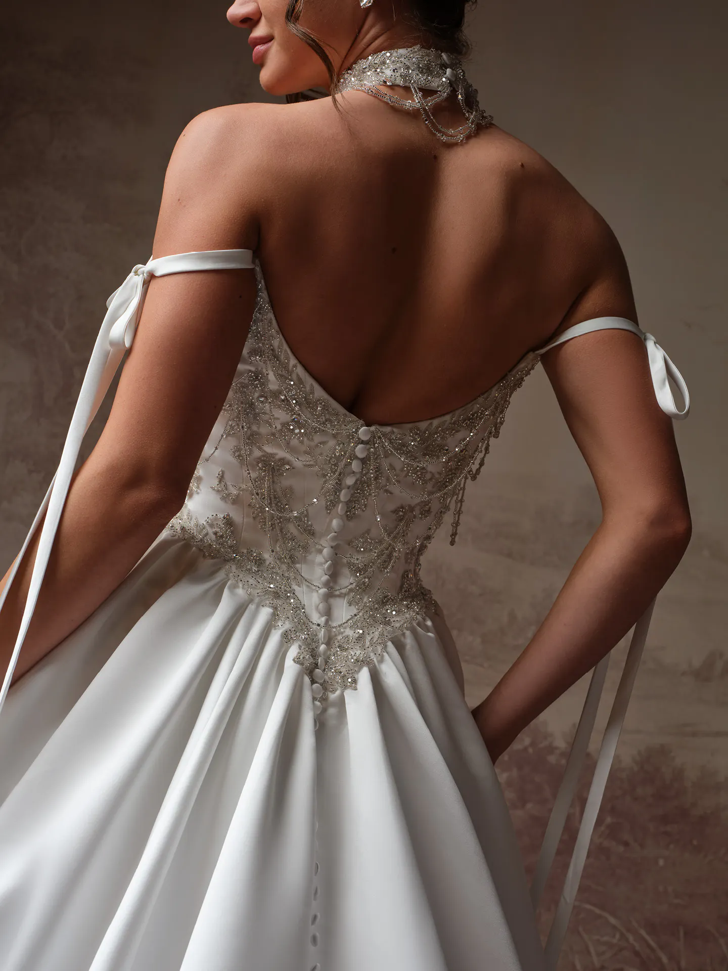 Sottero and Midgley Aelarion satin wedding dress back view with beaded bodice and ties.