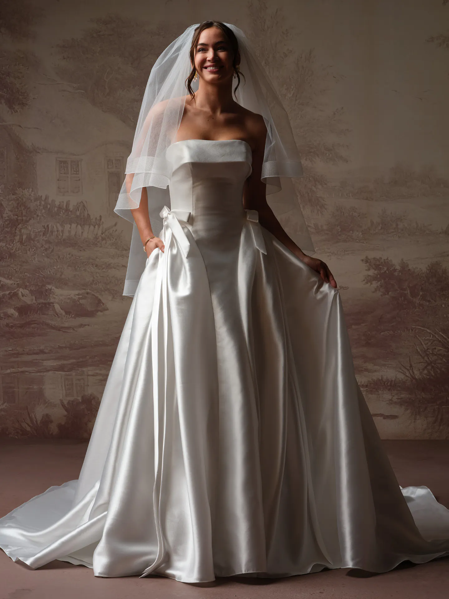 Sottero and Midgley Gemma satin ballgown, front view with side bow and veil.