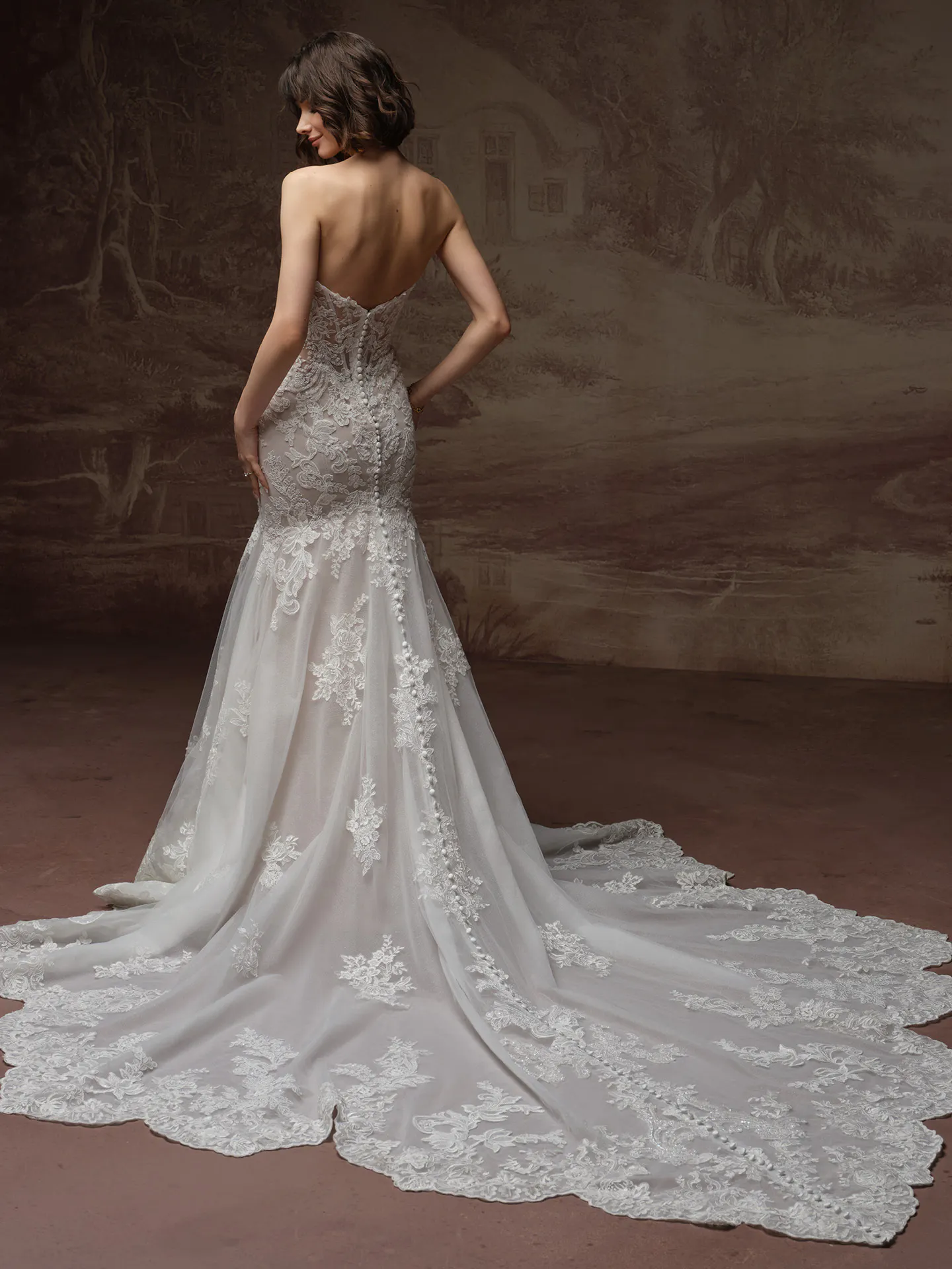 Sottero and Midgley Julianna, back view lace fit-and-flare dress with long train.