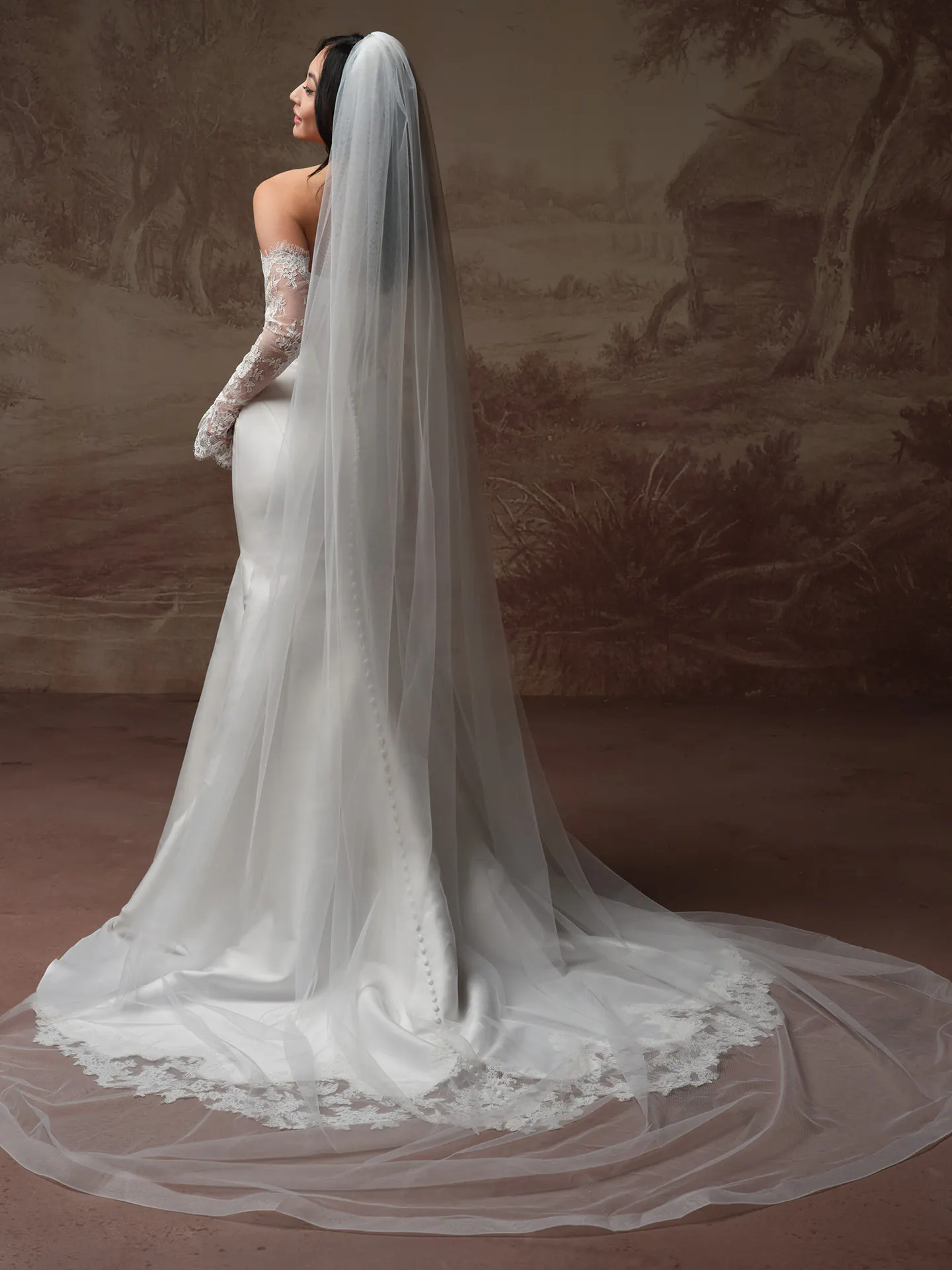 Rebecca Ingram sleek gown, back view with long veil and lace train.
