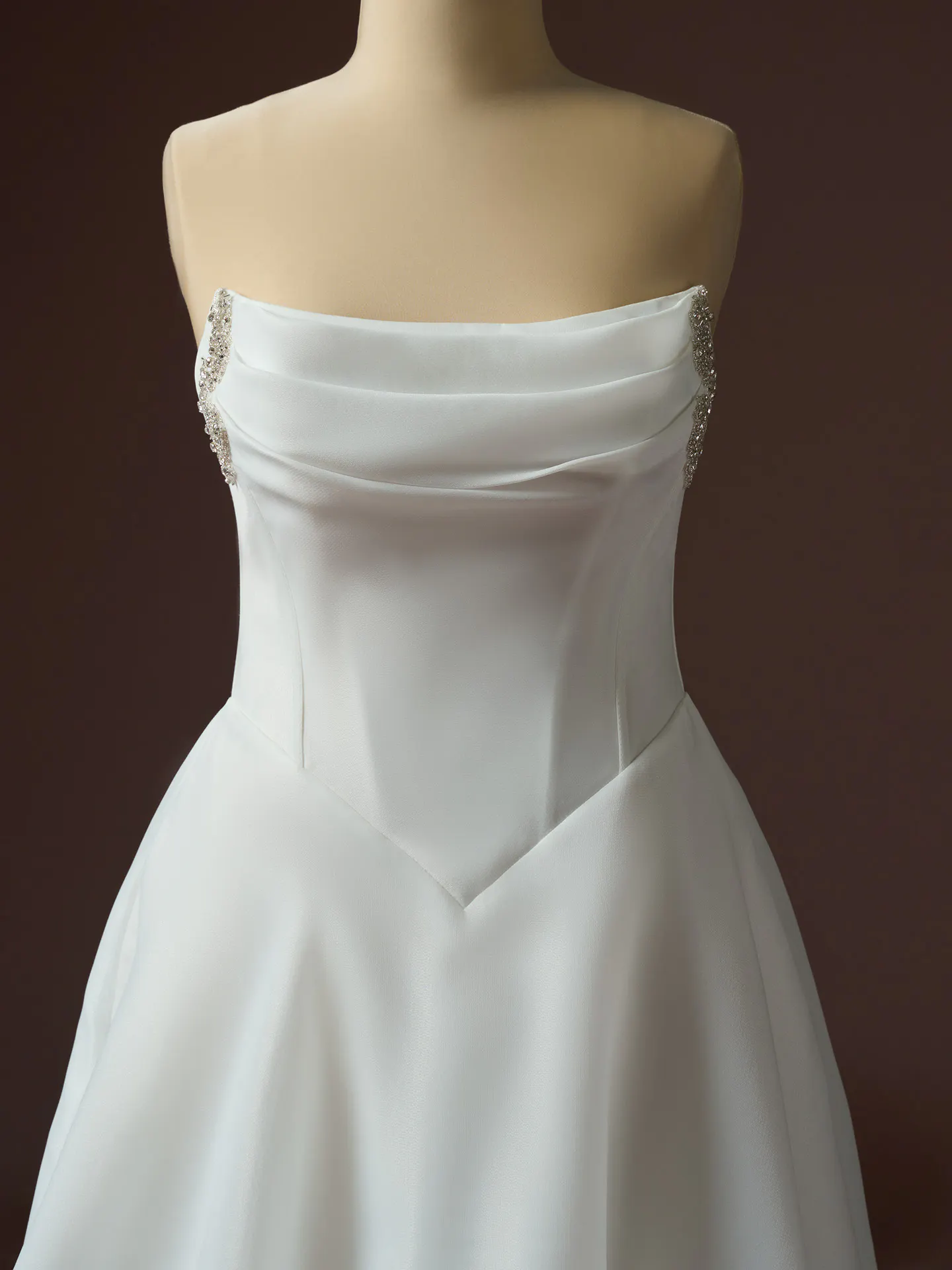 Maggie Sottero Abilene front view, organza A-line with basque waist, jeweled accents.