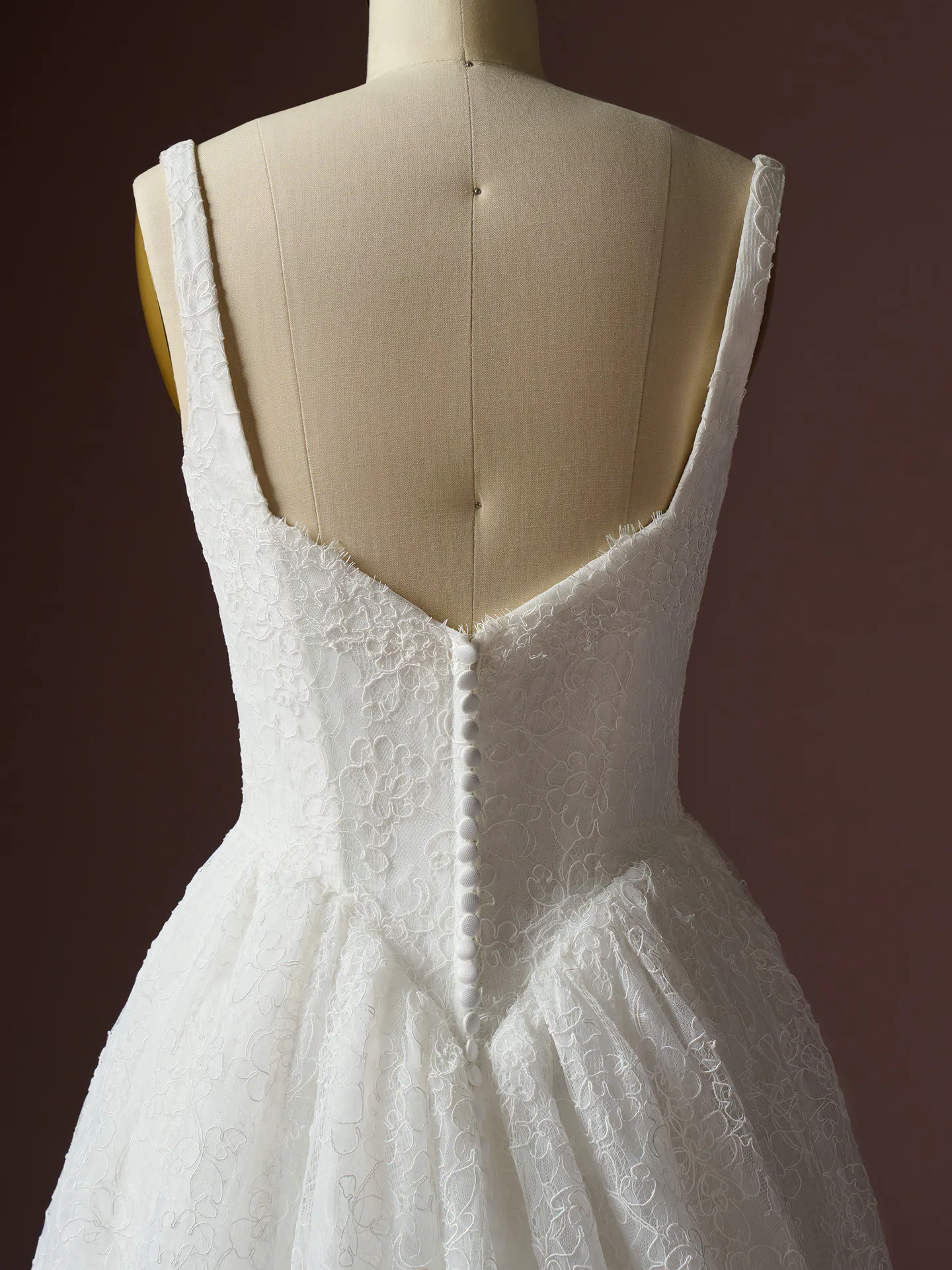 Maggie Sottero Autumn back view lace A-line dress on mannequin.