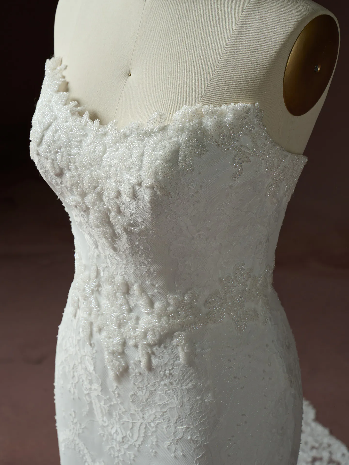 Maggie Sottero Collette lace dress close up beaded detailing.