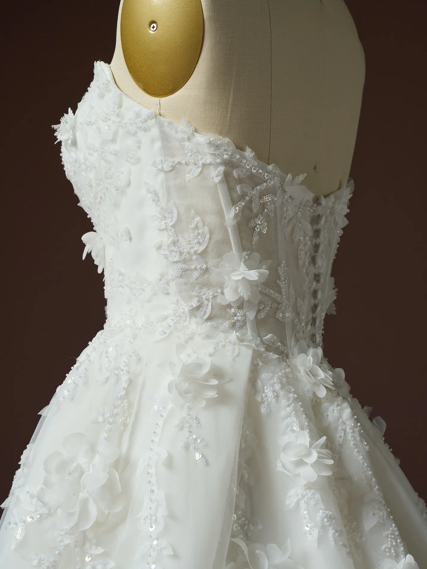 Maggie Sottero Fern side view 3 D floral lace wedding dress on mannequin.