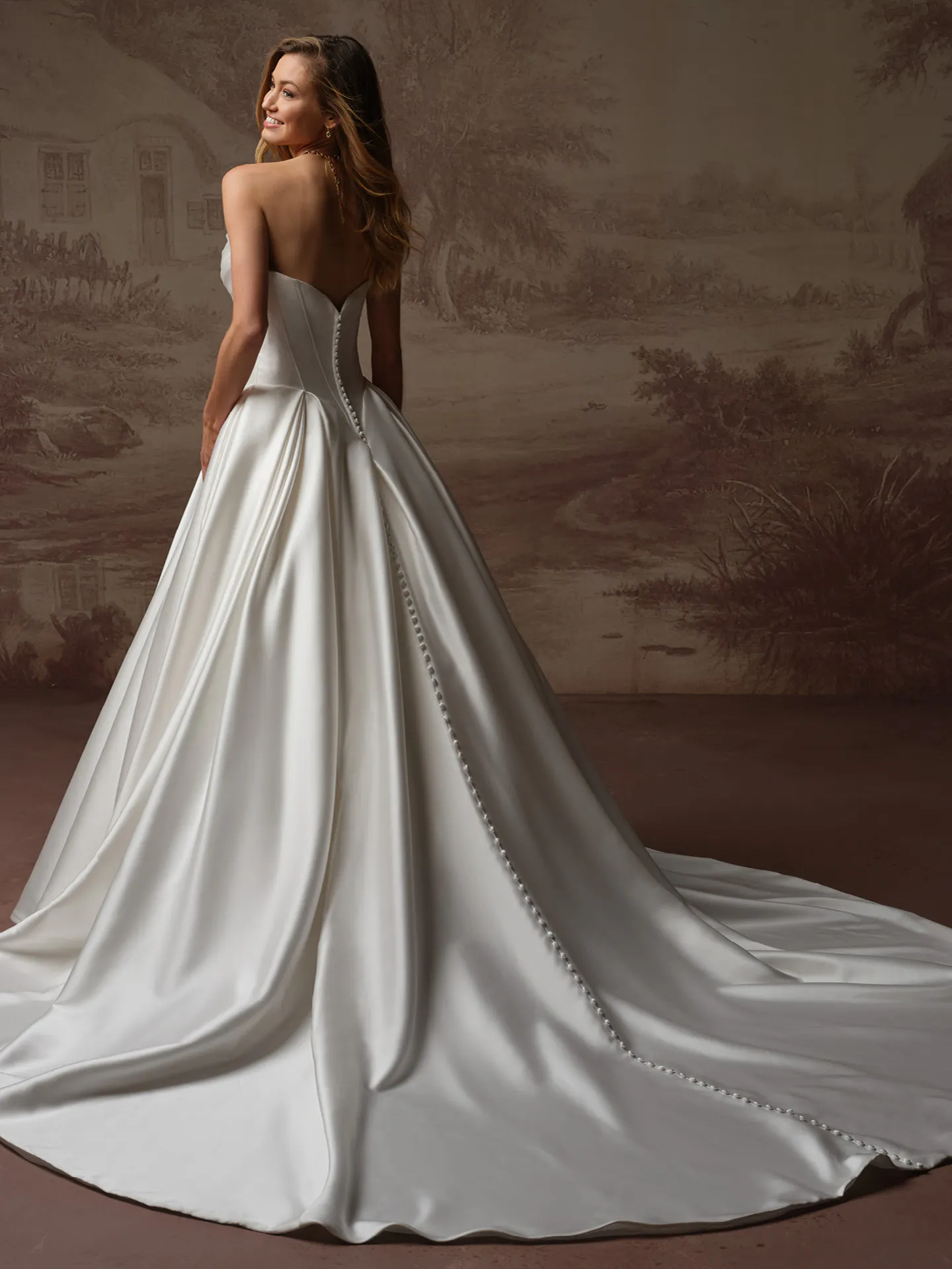 Maggie Sottero Fiorita back view; draped bodice, basque waist, buttons down train.