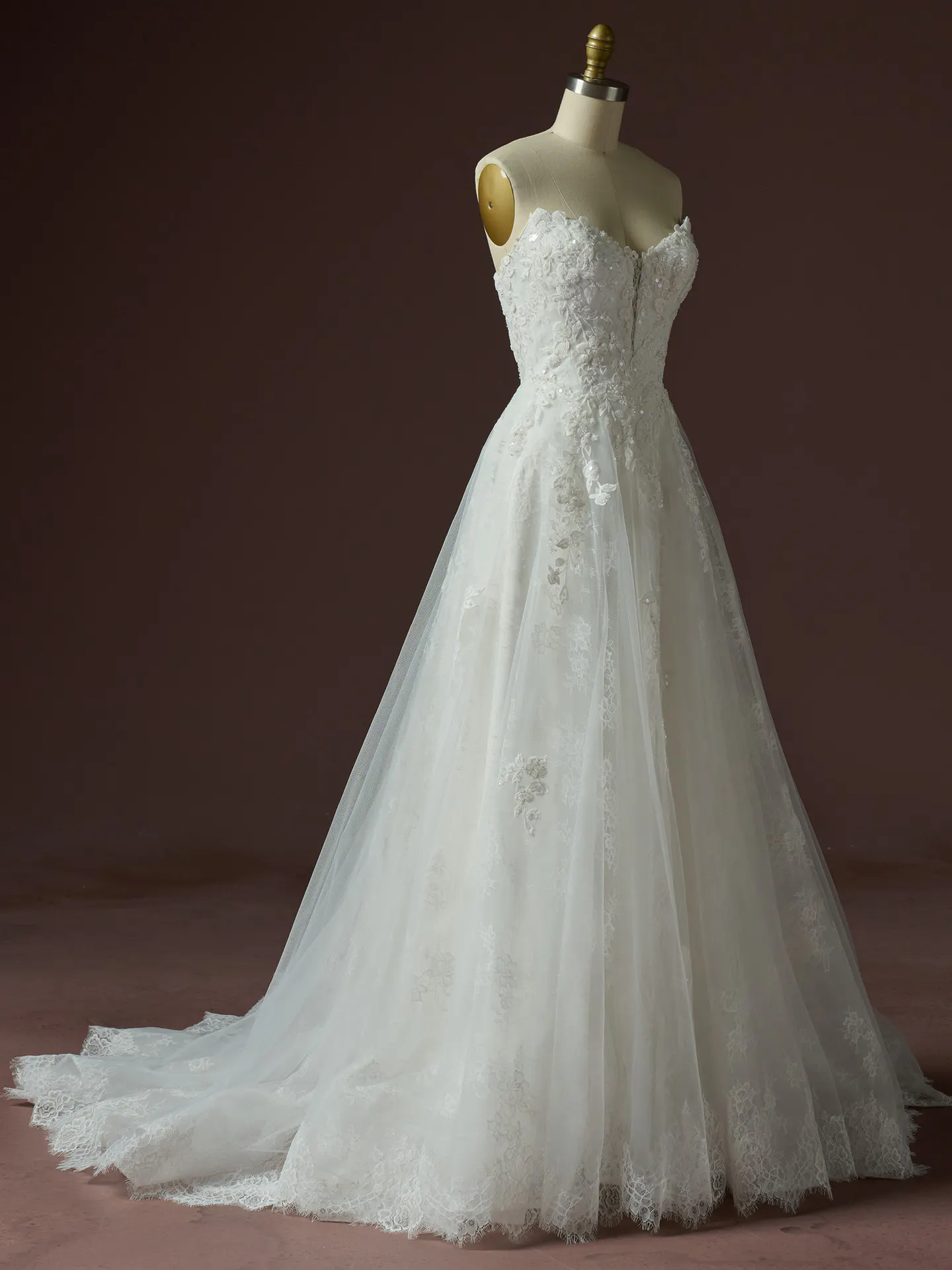 Maggie Sottero Hadley A Line beaded lace dress side view on mannequin.