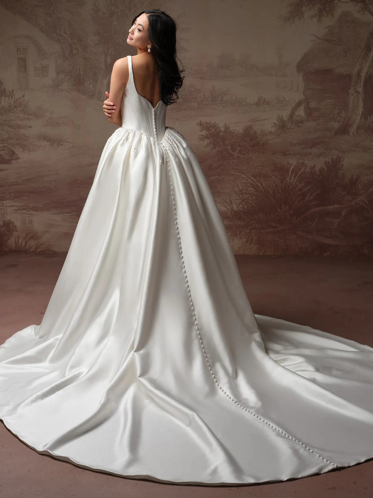 Maggie Sottero Melissa back view satin mermaid bridal dress with button detail.