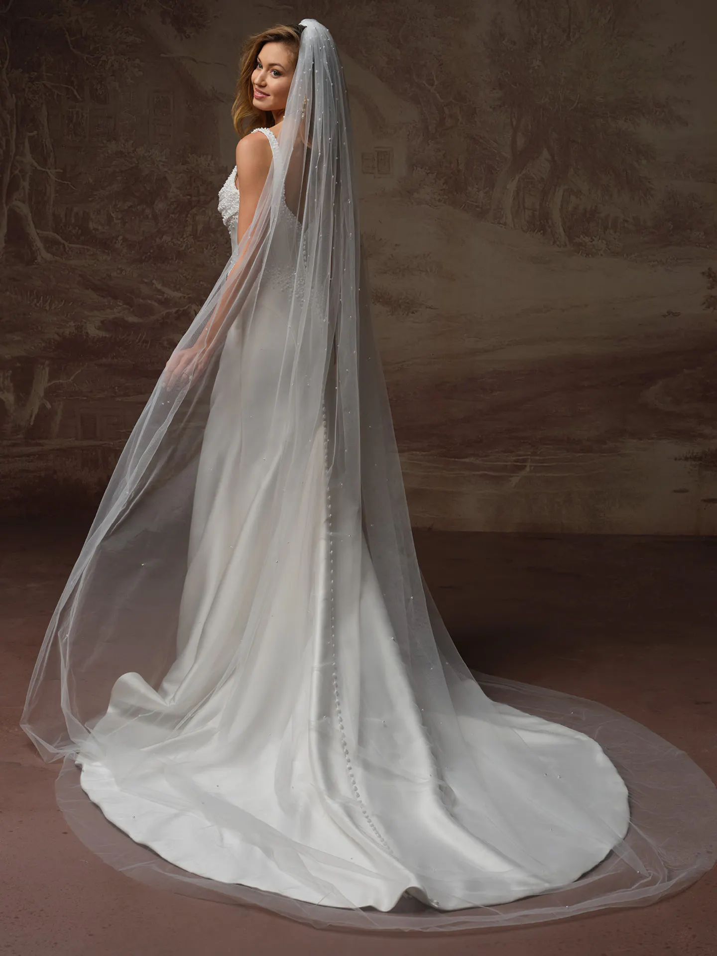 Maggie Sottero Melissa side view satin mermaid bridal dress with long veil.