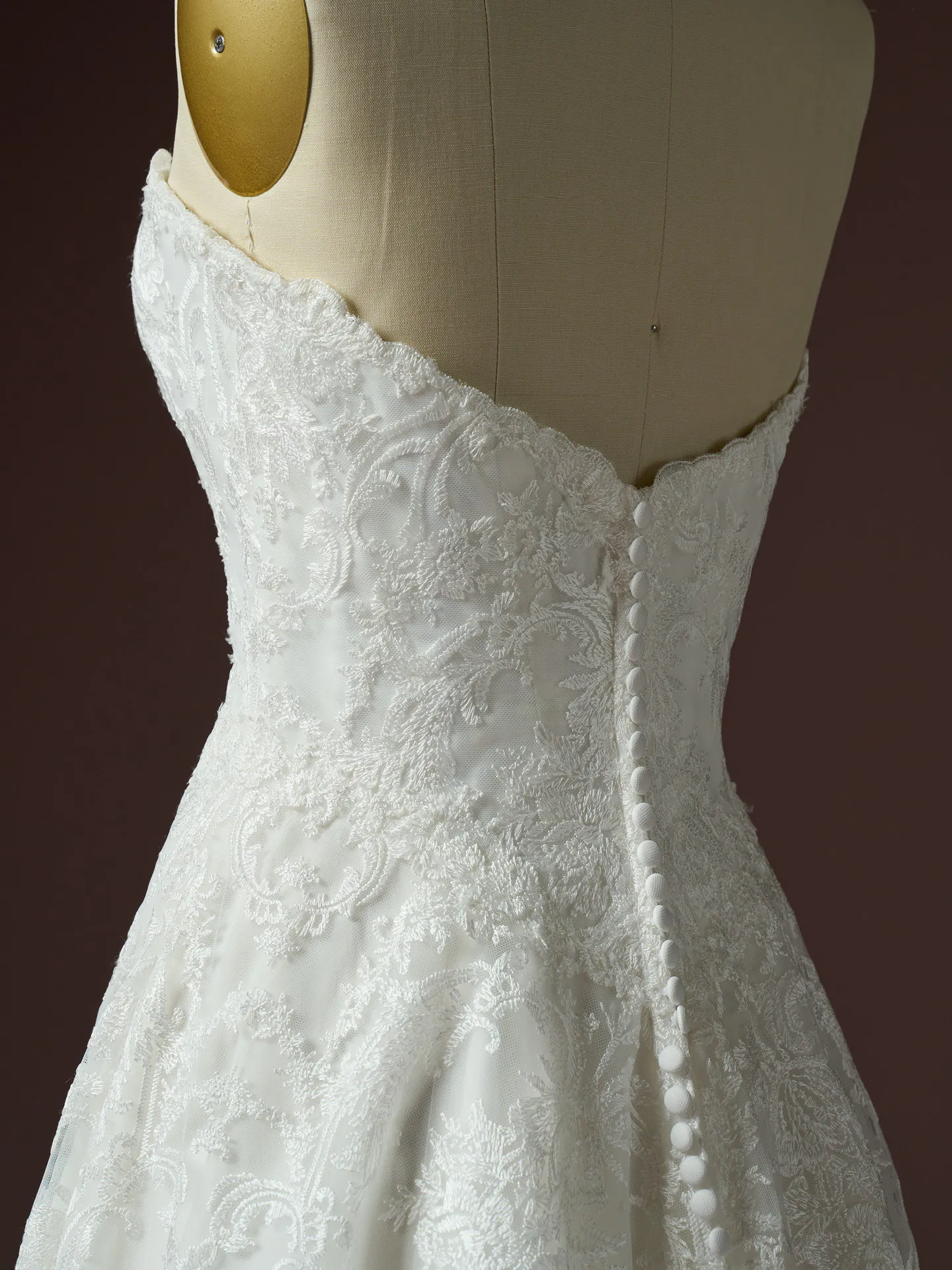 Maggie Sottero Zahia lace dress back view with button detail on mannequin.