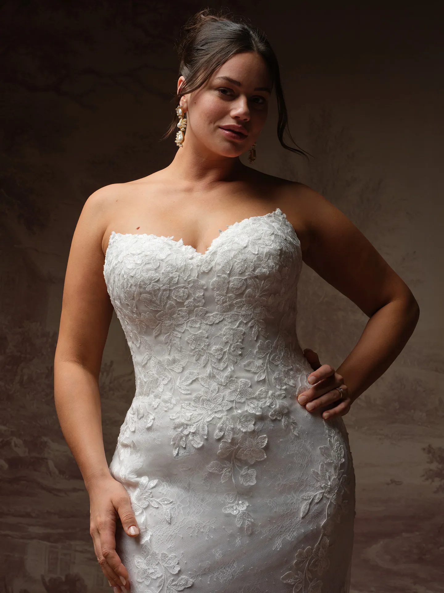 Rebecca Ingram Brandy fit-and-flare wedding dress with floral accents, front view.