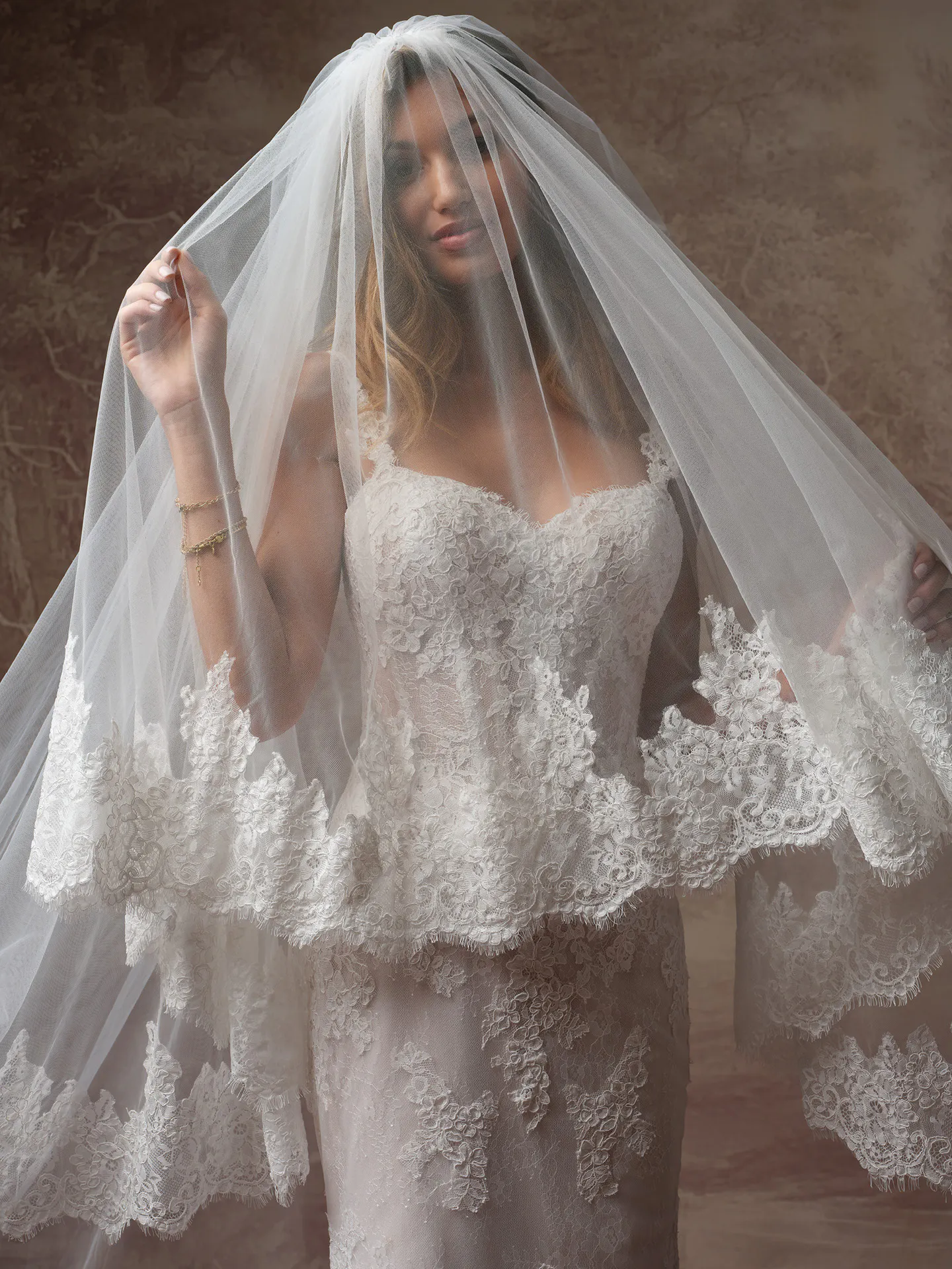 Rebecca Ingram Esmeralda lace fit-and-flare dress, front view with veil.