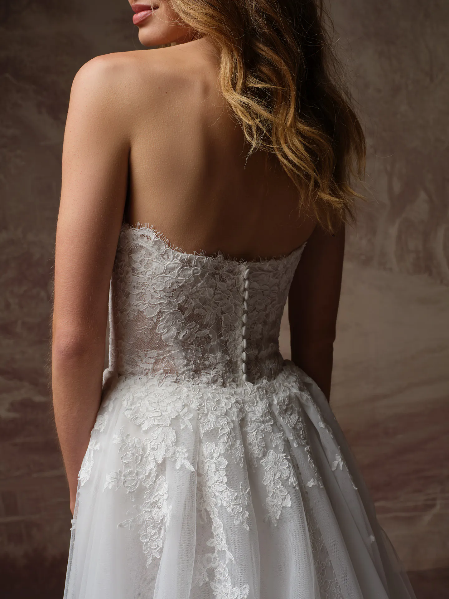Rebecca Ingram Esmeralda Lane, back view lace fit-and-flare wedding dress.