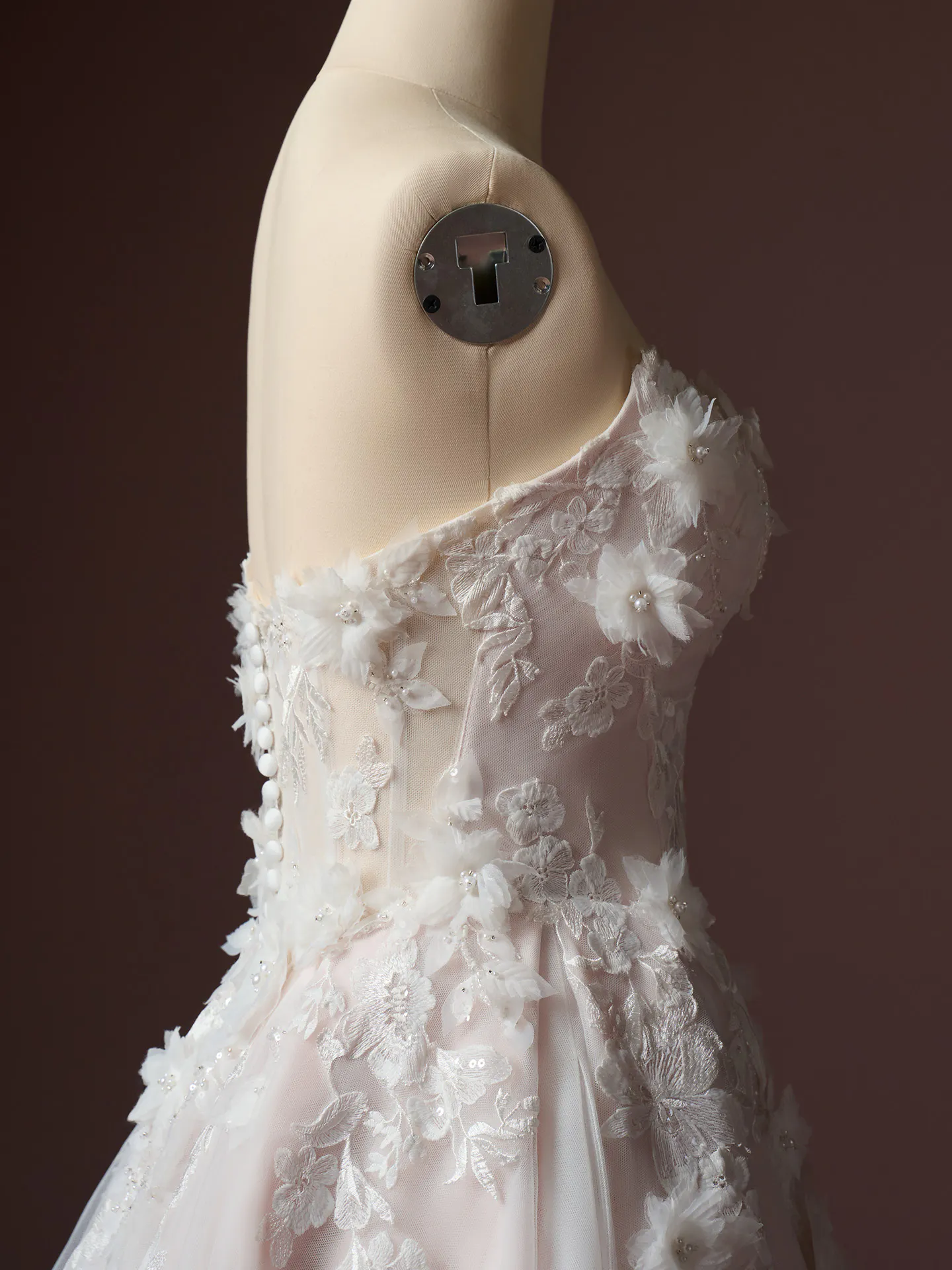 Rebecca Ingram Fleur, side view 3D floral beaded lace wedding dress on mannequin.