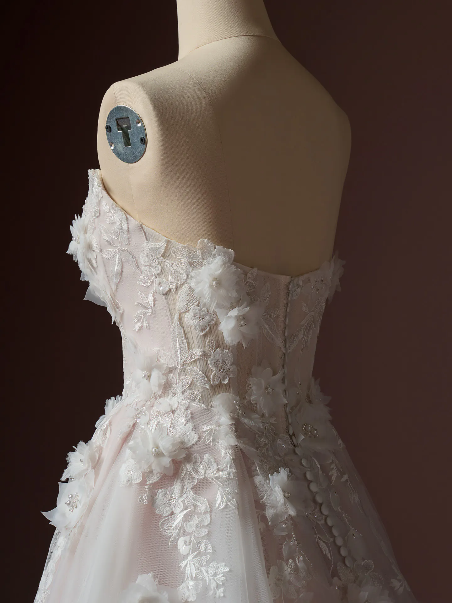Rebecca Ingram Fleur, back view, 3D floral beaded lace wedding dress on mannequin.