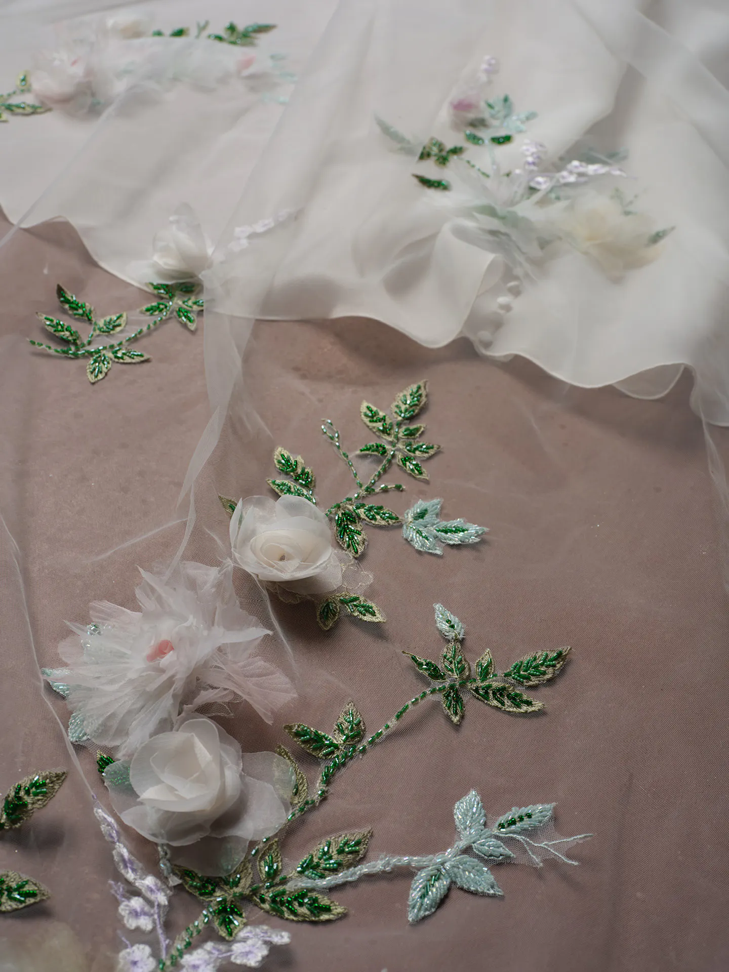 Sottero and Midgley Amaryllis dress with 3D floral details and green leaf embroidery.