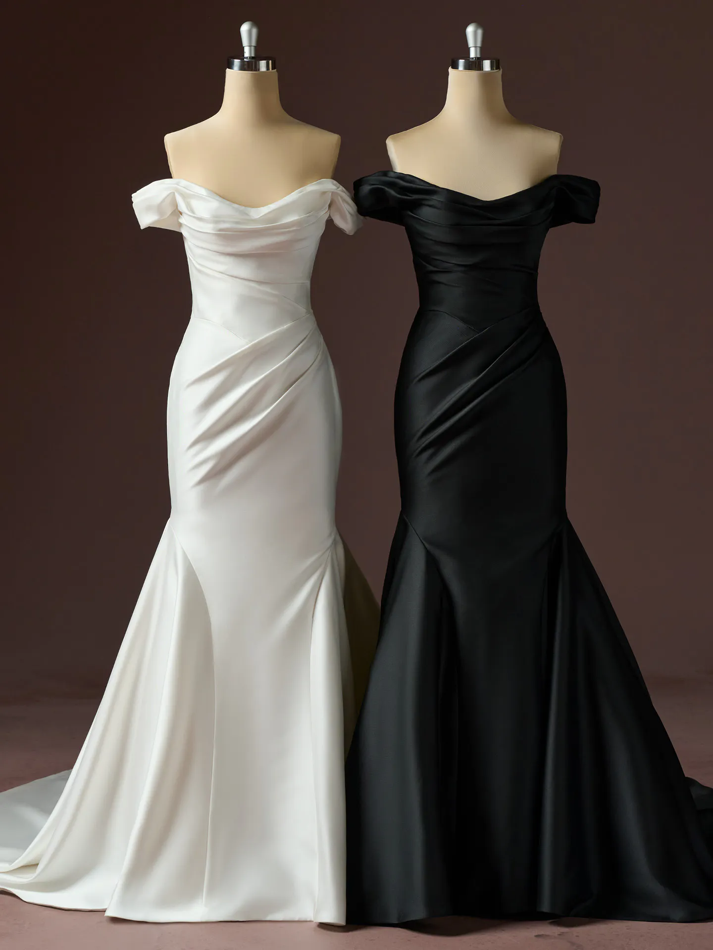 Sottero and Midgley Recine fit-and-flare satin dresses in white and black on mannequins.