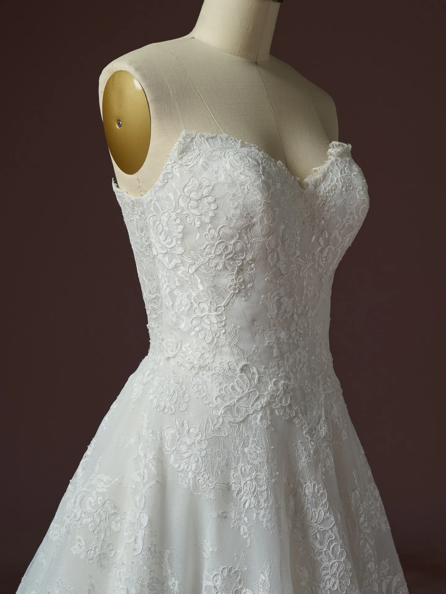 Sottero and Midgley Vespera lace A-line dress on mannequin, side view.