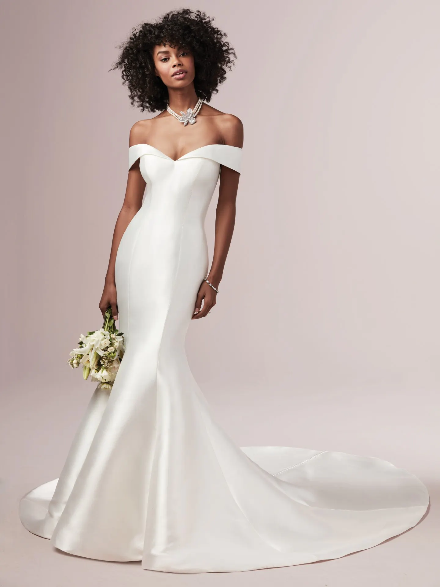 Rebecca Ingram off-the-shoulder fit-and-flare dress front view, model holding bouquet